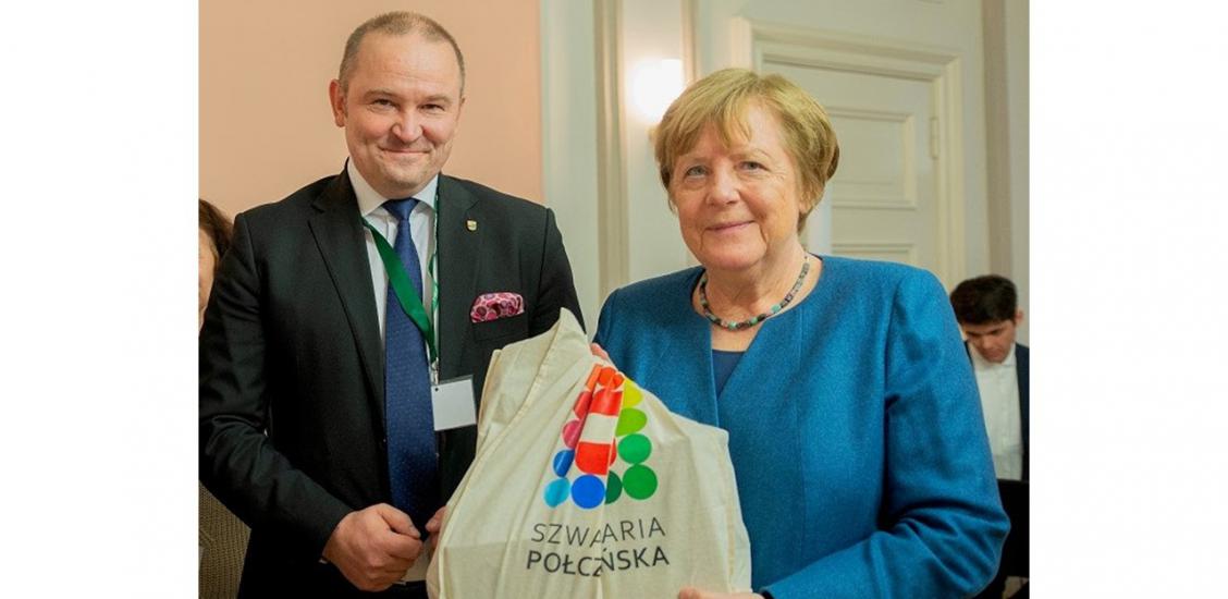 Der Bürgermeister von Połczyn-Zdroj Sebastian Witek und  Angela Merkel mit dem Logo der _Pommerschen Schweiz_